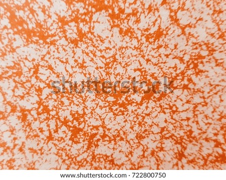 Orange and white pattern on the paper.