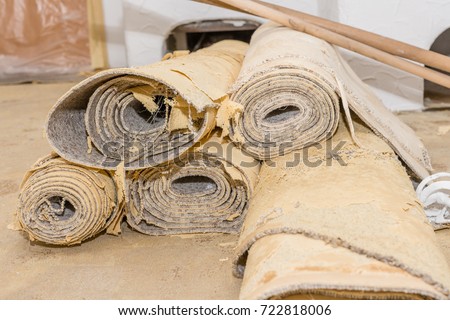 Removing a carpet for renovation works in a living room Royalty-Free Stock Photo #722818006