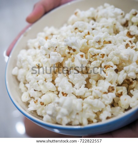 Popcorn bowl in kid hands