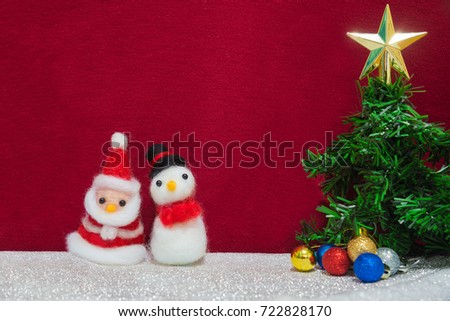 Santa claus, snowman wool doll, green xmas tree with glittering colorful ball, shiny star decoration with red cloth backdrop, happy new year and christmas concept background