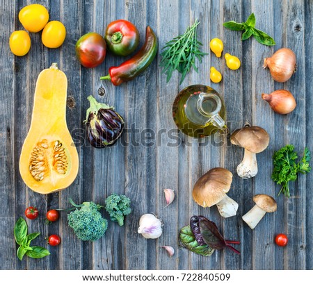 Vegetables mushrooms and herbs on wooden background with copyspase. 