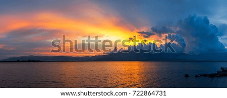 Beautiful sunset with mountain and lake background