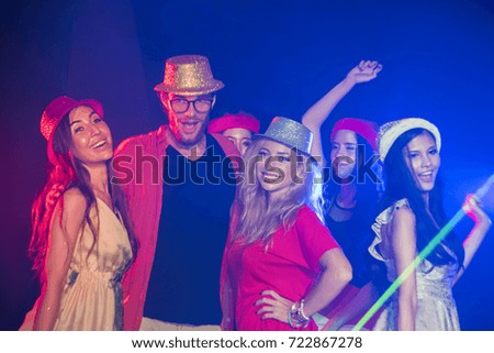 Party, holidays, celebration, nightlife and people concept - smiling friends dancing in club