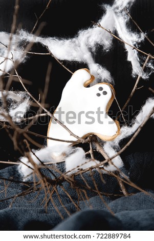 Sweet Halloween. Cookies in the form of ghosts, leaves and pumpkins. Dark background. Space for text