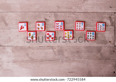 Develops fine motor skills and logical thinking.children's early development, logic and reasoning.The ability to add and subtract.basic knowledge in mathematics.Numbers on wooden background.Copy space
