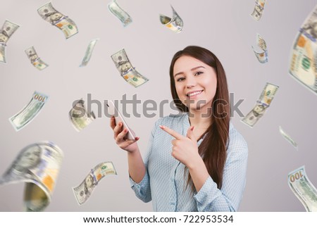 girl with a phone in hands on a background of rain out of money