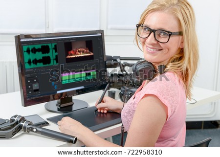 young blond woman designer using computer for the video editing