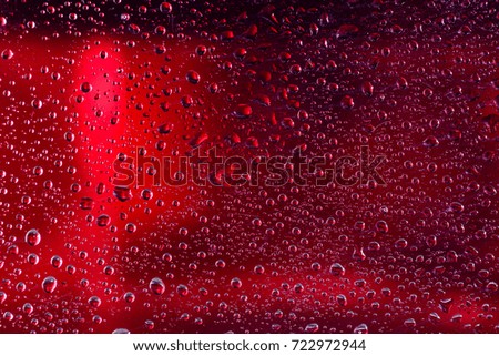 Drops of water on red surface. Macro abstract photo, background, texture