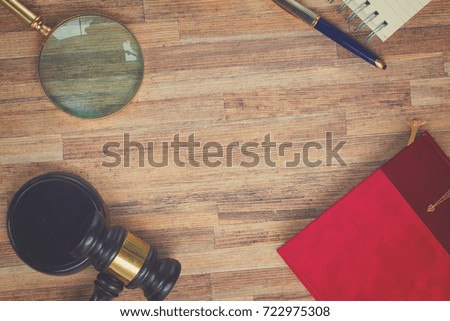 Wooden Law Gavel with legal book, looking glass and pc keyboard, retro toned