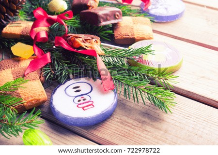 christmas sweets on wooden background. pine tree branches