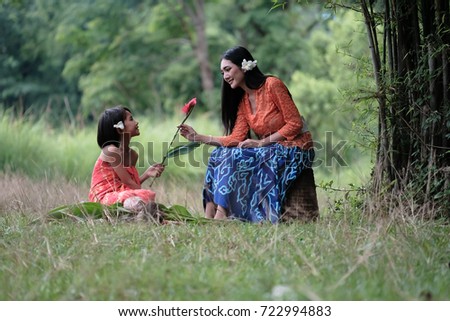 beautiful girl and young woman thai traditional culture at the field in Thailand
