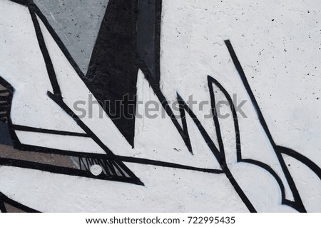 Background image of a concrete wall with a piece of abstract graffiti pattern. Street art, vandalism and youth hobbies
