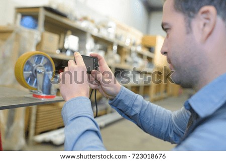 engineer using a digital tablet to take a picture