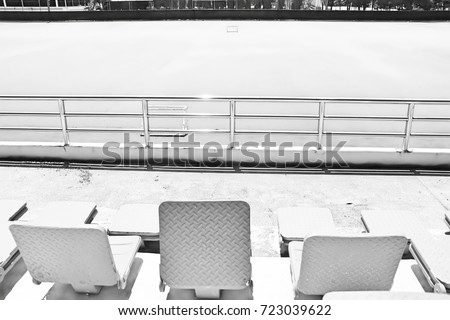 The seats is made of steel in sport stadium of Thailand. Black and white picture.