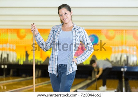 woman cleaning a bowling center