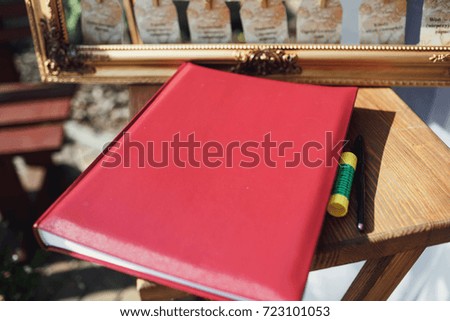 Red notebook and pen behind it