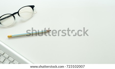 Office desk table Top view  keyboard and glasses with pencil on white background