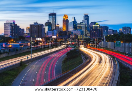 beautiful Minneapolis skyline with traffic light at night.