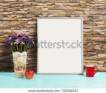 Silver frame mockup with field flowers in vase, apple and mug. Empty frame mock up for presentation design. Template framing for modern art.