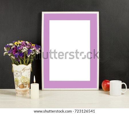 Fame mockup with field flowers in vase, apple, mug and candle. Empty frame mock up for presentation design. Template framing for modern art.
