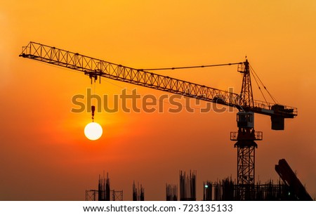 Silhouette Crane in building construction site on Sunset Background