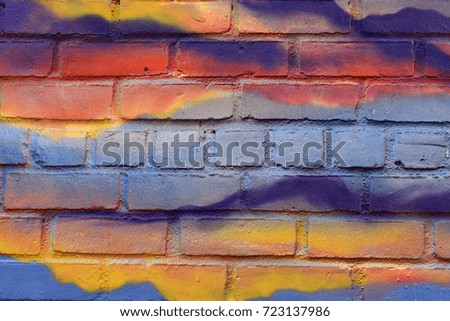Orange, Blue, and Purple Spray Paint on Brick