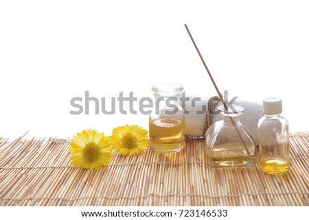 yellow flower with rolled towel, bottle oil on bamboo, mat 