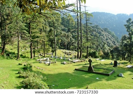 Green lawn with cross stone symbol on graveyard, Old cemetery in Dharamsala, INDIA 