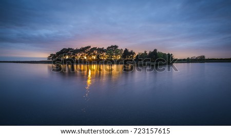 Hatchet Pond in the New Forest at sunset. Royalty-Free Stock Photo #723157615