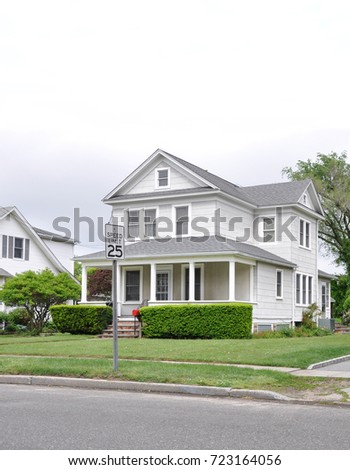Suburban Home with porch overcast sky USA