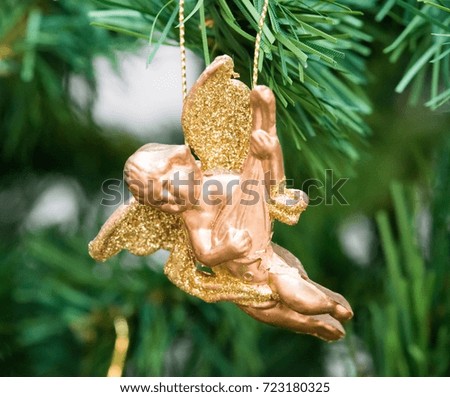 Christmas angel playing a mandolin with golden decoration