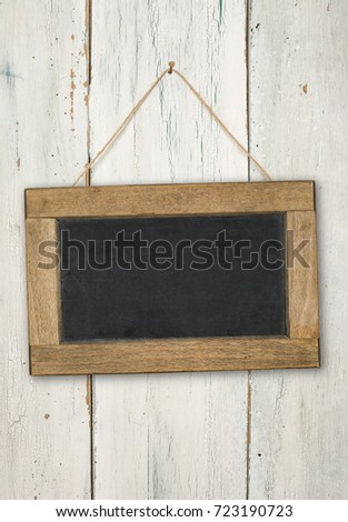 Empty blackboard on a rustic white wooden wall