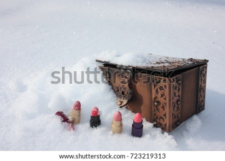 winter catalog cover. a casket and a lipstick in a row. photo for your design.