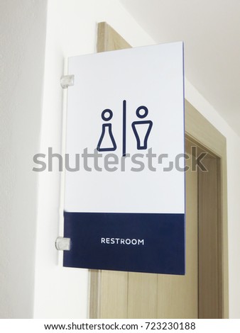 Toilet sign on a wooden door.