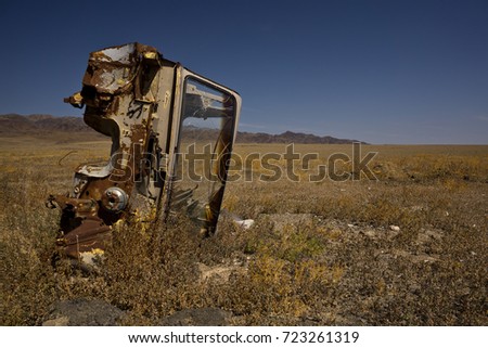 old and abandoned truck turned on the side in the steppe, Kazakhstan