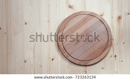 Background for product montage. empty round wooden board for cutting on a wooden background with copy space