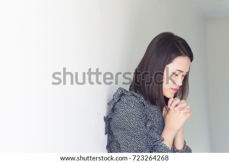 Woman close her eyes and praying in the morning.Woman hand praying,Hands folded in prayer concept for faith, spirituality and religion.