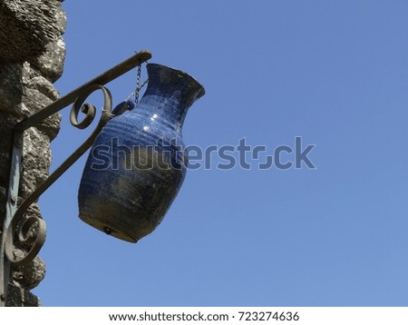Hanging sign of pottery workshop on blue sky background