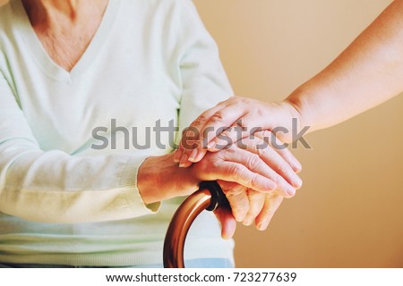 Senior woman with her caregiver at home. Concept senior people health care. Royalty-Free Stock Photo #723277639