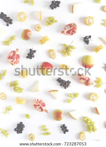 Concept of healthy food. Berries and fruit pattern. Slices of red apples,melon, pomegranate, black and green grapes on a white background. Vertical composition of  fruits, top view. Food collage.	