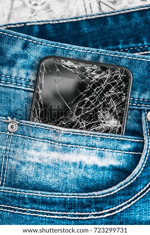 Black Smart Mobile Phone With Broken Screen in  Denim Pocket