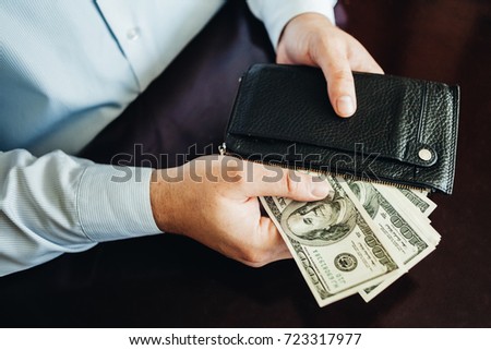 hundred dollar bills on a wooden background