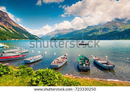 Boats on the Sils lake. Colorful morning view in Swiss Alps, Maloja pass, Upper Engadine in canton of the Grisons, Switzerland, Europe. Traveling concept background.

