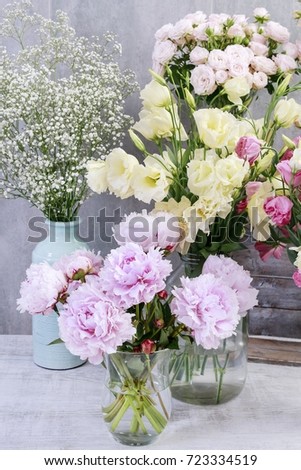 Bouquet of pink peonies and other plants in flower shop.