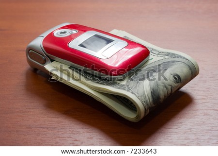 Cellular telephone with a pack of dollars