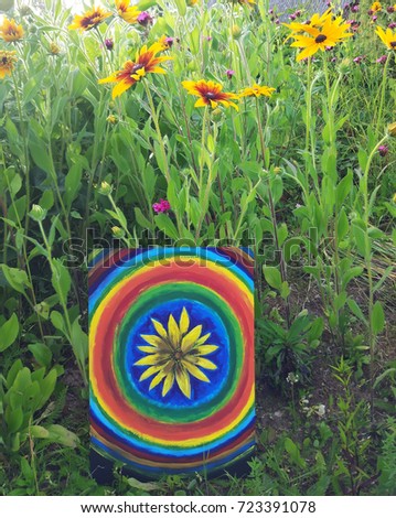 Abstract painting by oil on canvas in the summer park. Yellow rudbeckia flower and rainbow circles.