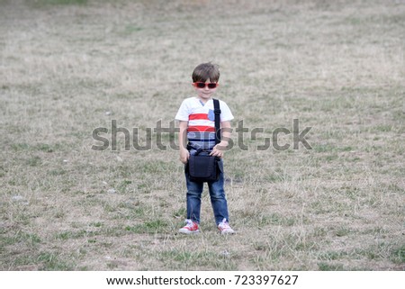 Portrait of little boy with sunglasses. Four years old boy in the park