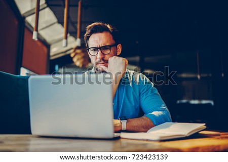 Depressed male entrepreneur feeling headache can't solve problems with finance checking report on netbook.Stressed manager worried about documentation on laptop failure with saving on software