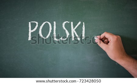 Hand writing on a blackboard in a language class with the word "Polish" written on it.  Royalty-Free Stock Photo #723428050