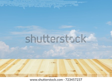 Empty blue sky and white cloud montage with wood table for background.